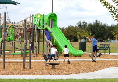 Green playground slide and children. No dog area visible.